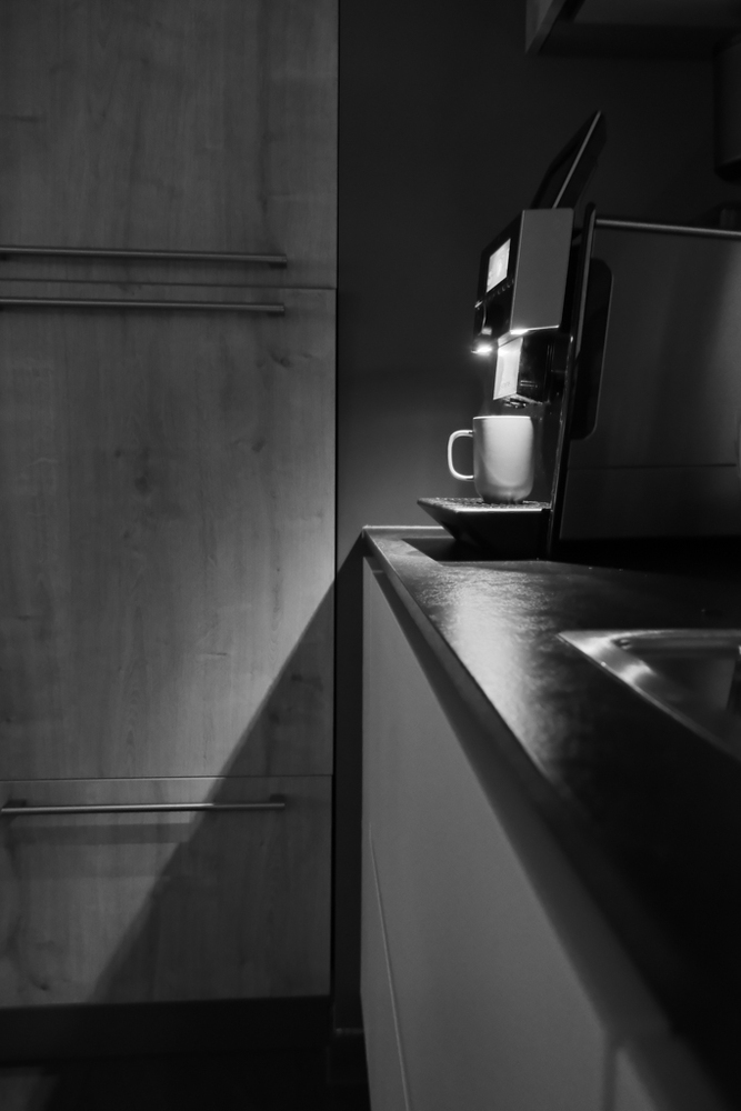 Foto vom Schatten, die das Licht einer Kaffemaschine wirft